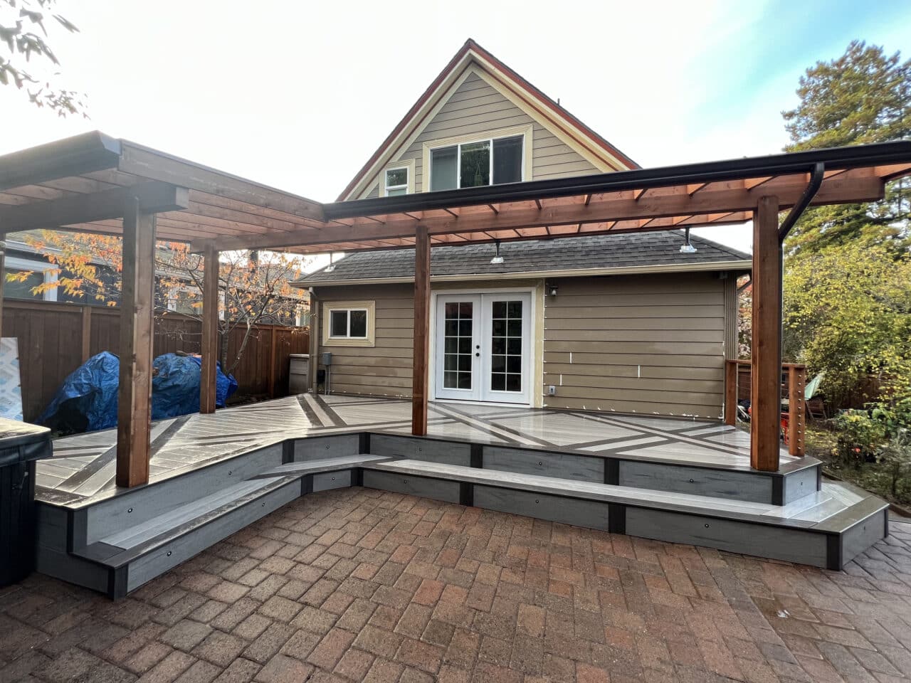 Multi-level deck with pergola and deck inlays, pattern, and steps