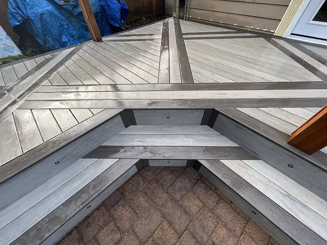 Photo of a composite deck with deck inlays and a deck cover