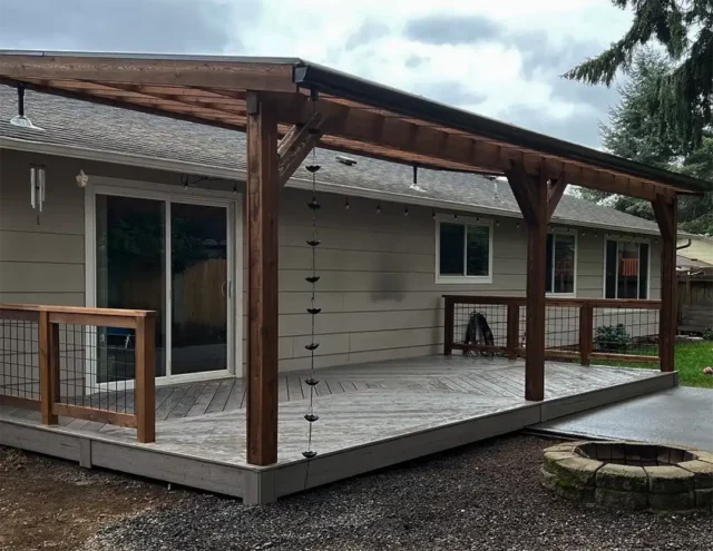 composite deck with pergola and deck boards arranged in a pattern