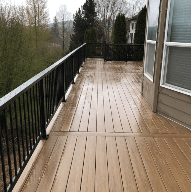 photo of a composite deck with black railing - Deck design ideas