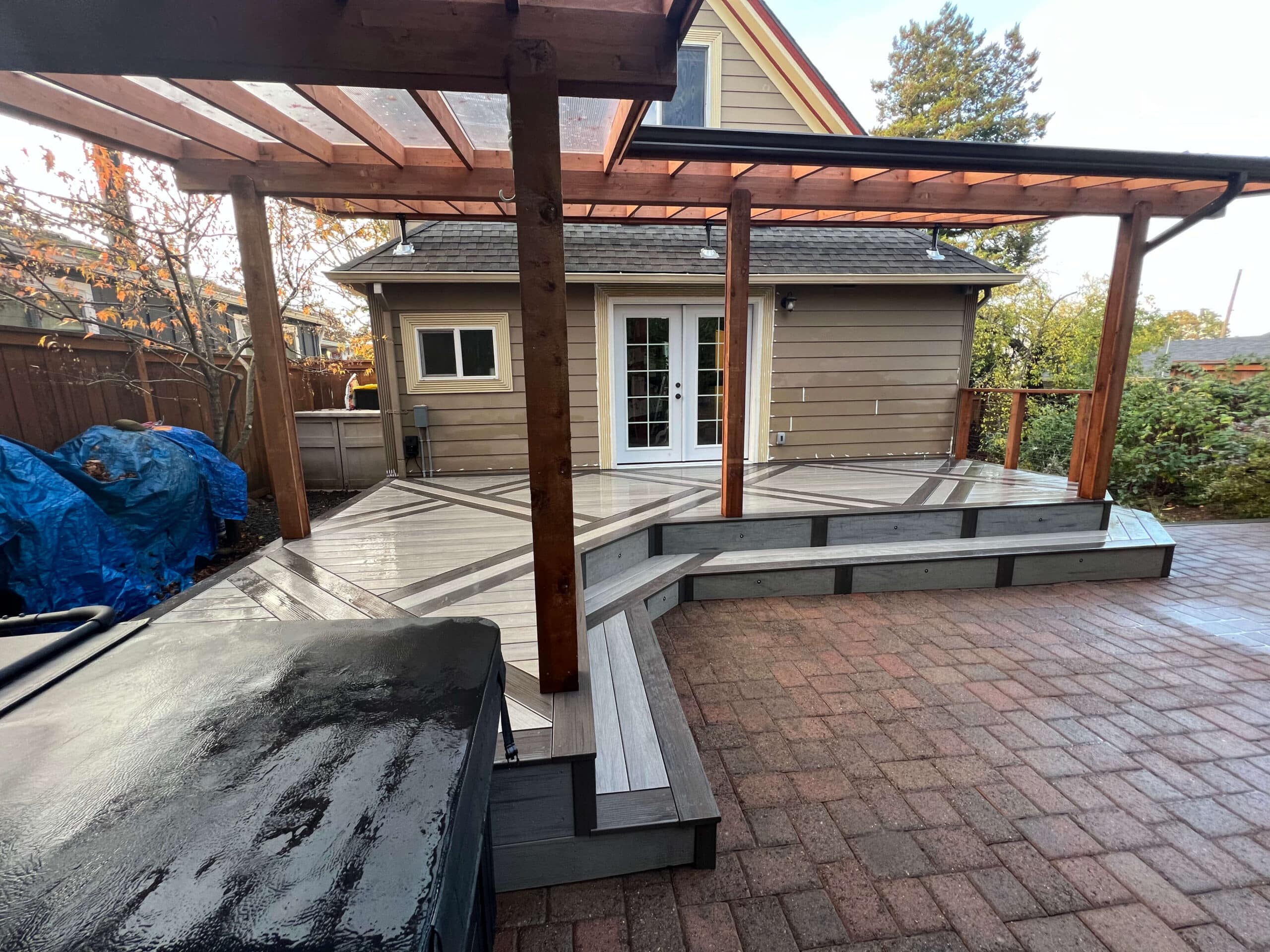 photo of a covered deck with basket weave inlay and hot tub scaled